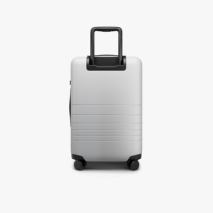 Monos Carry-On Pro Plus Luggage (23"), Hardside Spinner Suitcase with TSA Lock & Front Pocket, Airline Approved, Stellar White