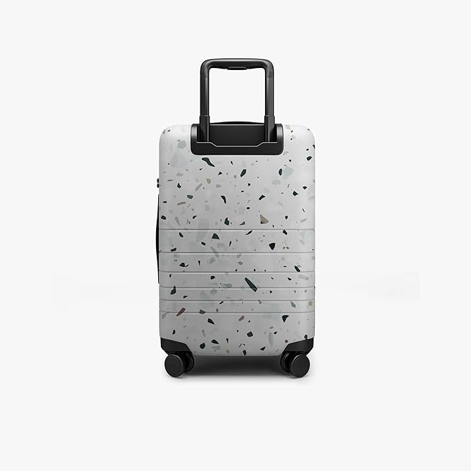 Monos Carry-On Pro Plus Luggage (23"), Hardside Spinner Suitcase with TSA Lock & Front Pocket, Airline Approved, Terrazzo, White