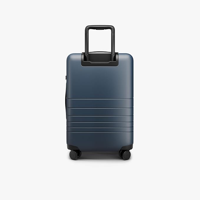 Monos Carry-On Pro Plus Luggage (23"), Hardside Spinner Suitcase with TSA Lock & Front Pocket, Airline Approved, Ocean Blue