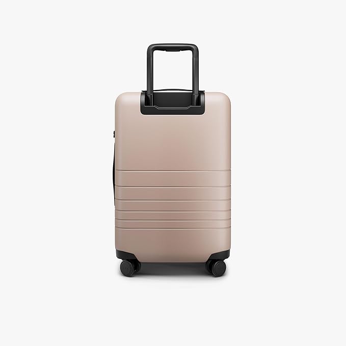 Monos Carry-On Pro Plus Luggage (23"), Hardside Spinner Suitcase with TSA Lock & Front Pocket, Airline Approved, Rose Quartz, Pink