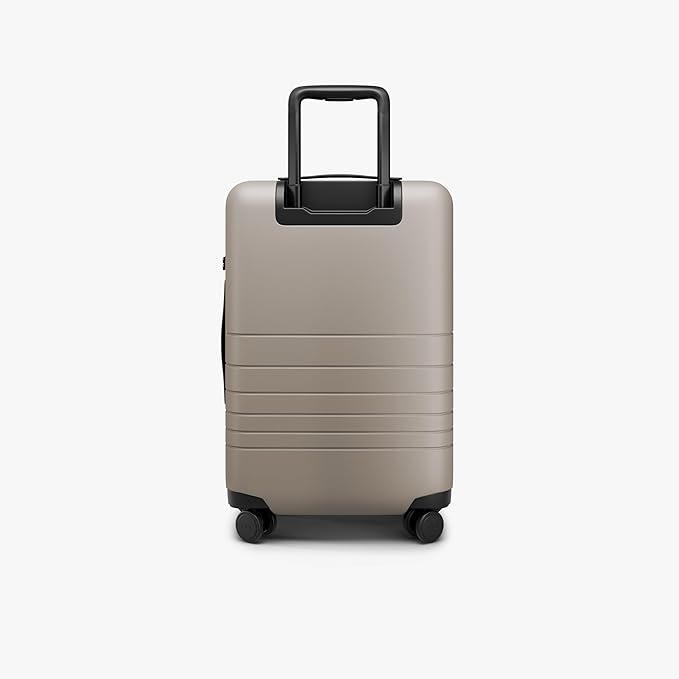 Monos Carry-On Pro Plus Luggage (23"), Hardside Spinner Suitcase with TSA Lock & Front Pocket, Airline Approved, Desert Taupe, Beige
