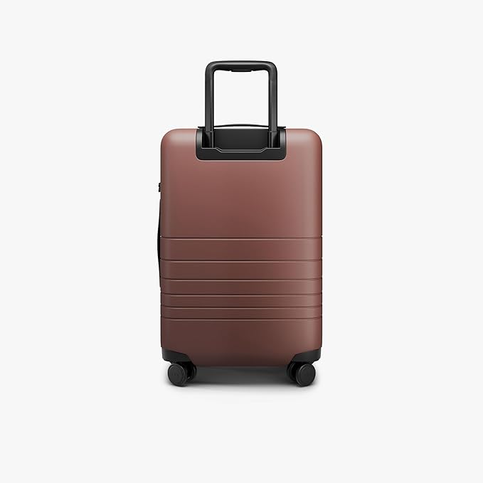 Monos Carry-On Pro Plus Luggage (23"), Hardside Spinner Suitcase with TSA Lock & Front Pocket, Airline Approved, Terracotta, Red